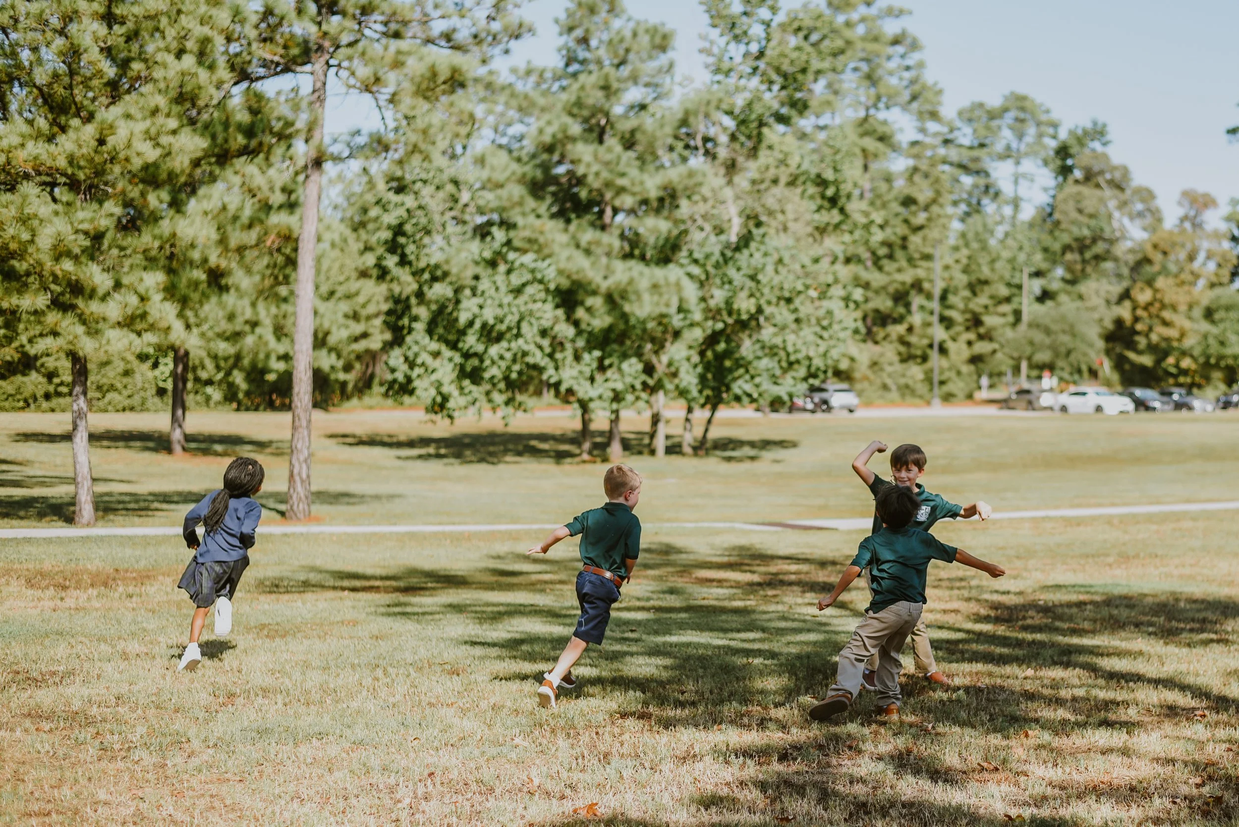 Students running across a grassy field