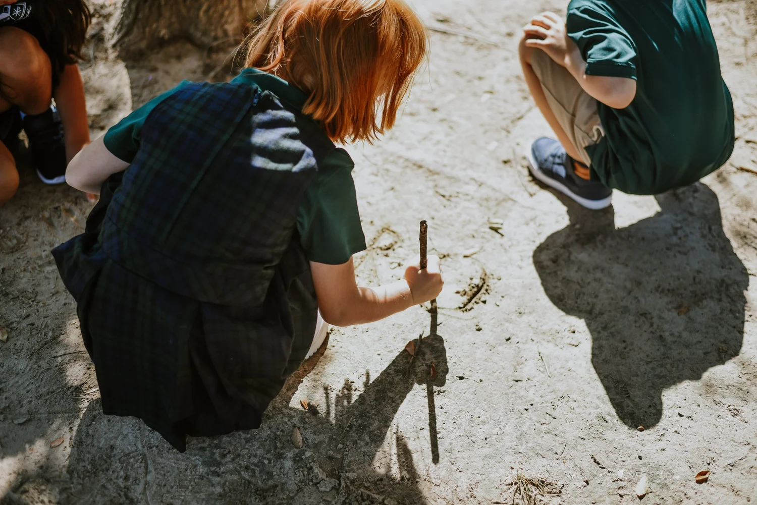 Young students exploring in a garden bed