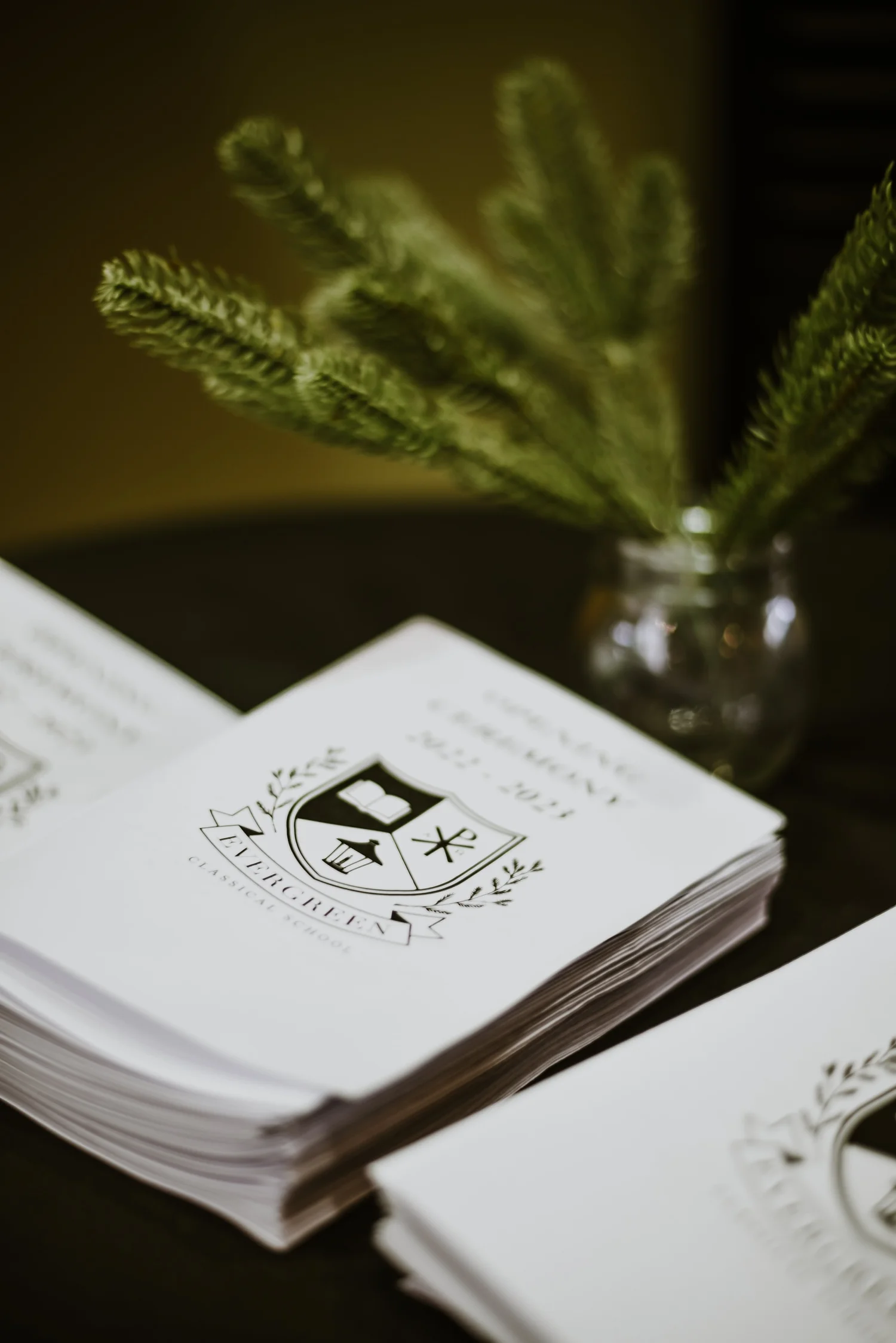 Evergreen handbooks bearing the school crest