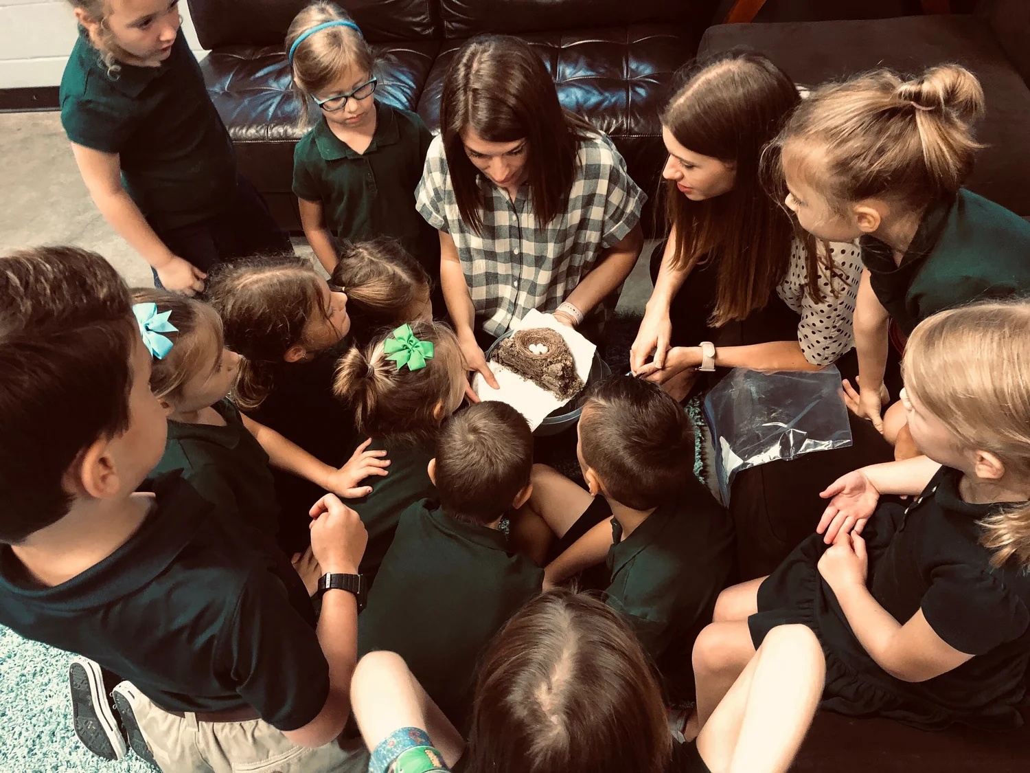 Students gathered closely around a book