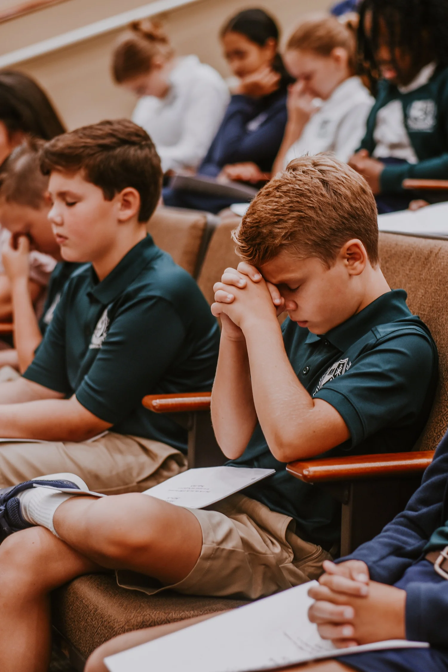 Students bowing their heads in prayer